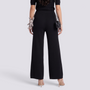 Essyro high-waisted black wide-leg knit trousers with a ribbed texture, worn by a woman from the back view.