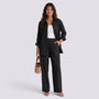 Essyro black two-piece set with a loose long-sleeve shirt and wide-leg trousers worn by a smiling woman