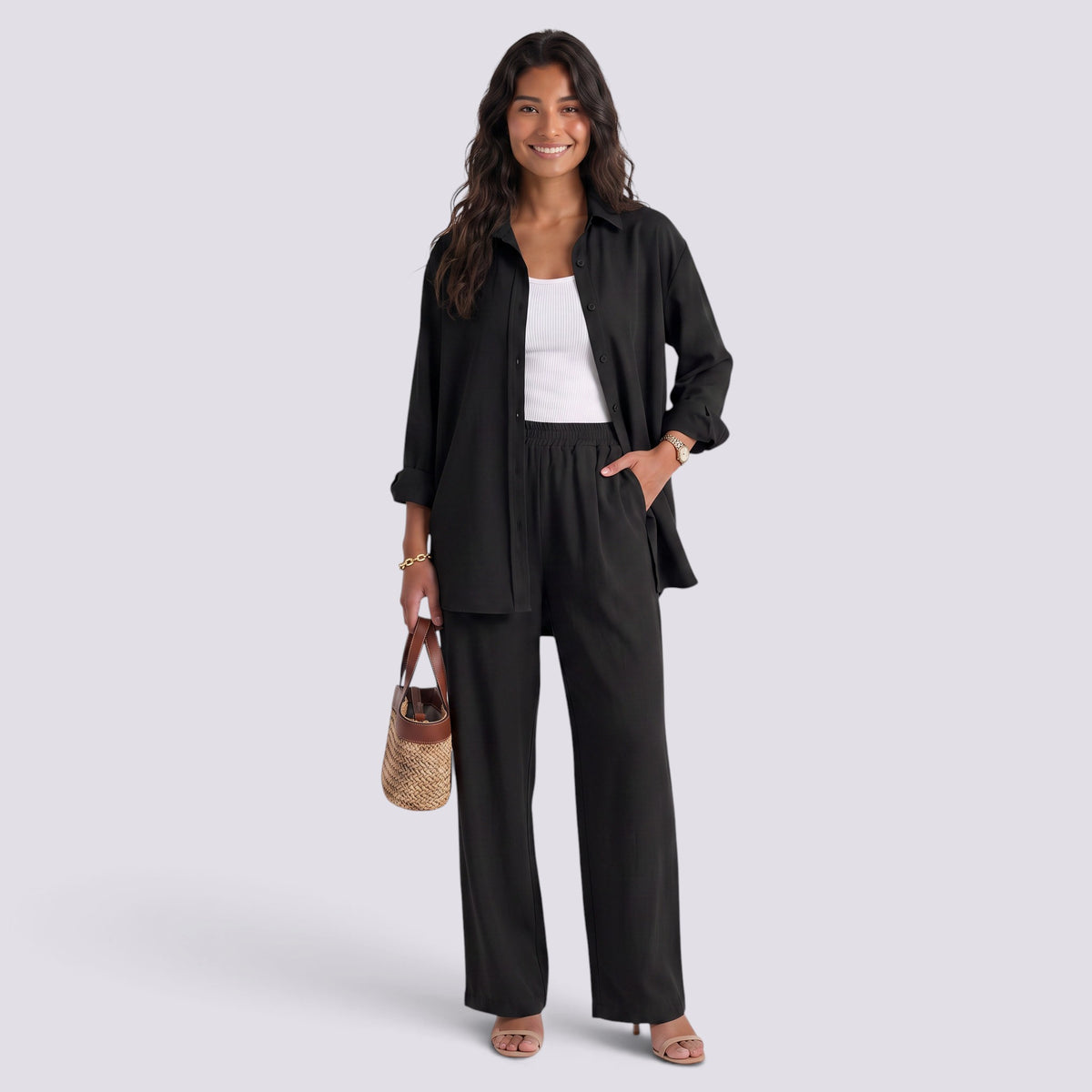 Essyro black two-piece set with a loose long-sleeve shirt and wide-leg trousers worn by a smiling woman