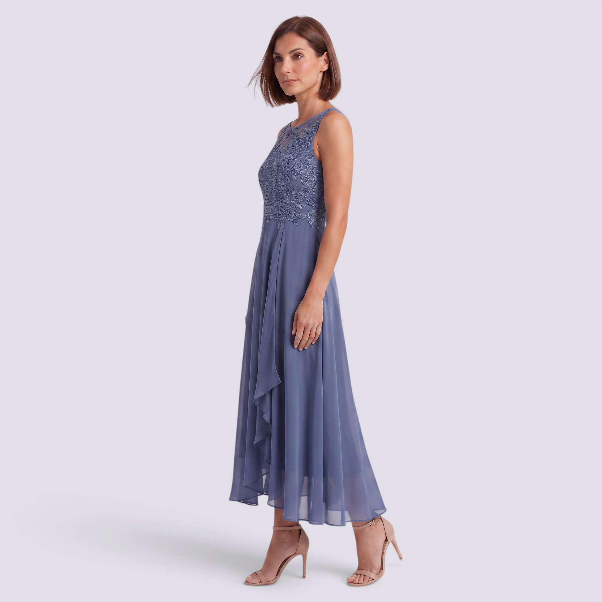 Essyro blue midi dress with V-neck, lace bodice, and flowing skirt worn by a woman with heels for a formal event.
