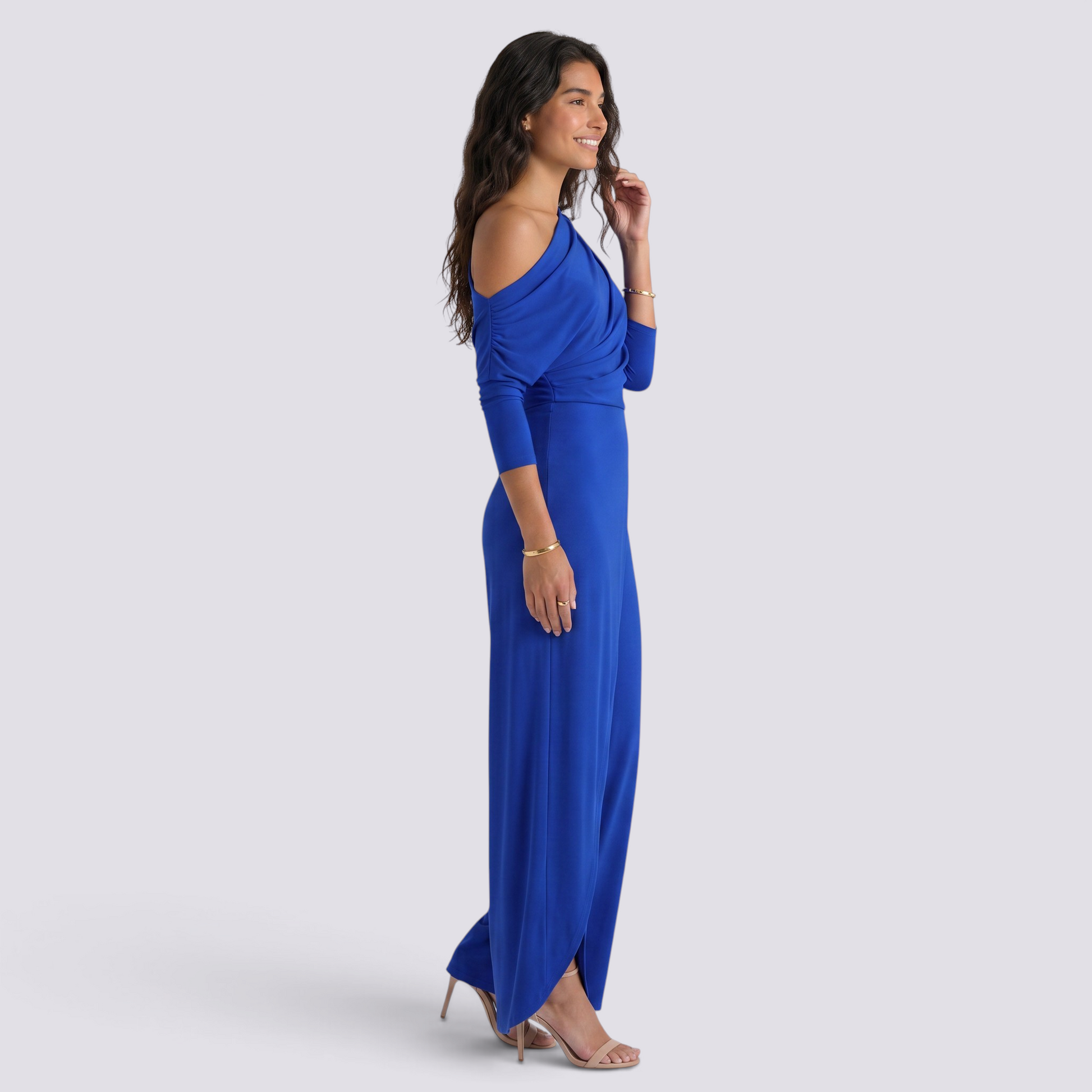 Essyro royal blue one-shoulder jumpsuit with draped long sleeve and wide-leg silhouette on a smiling model