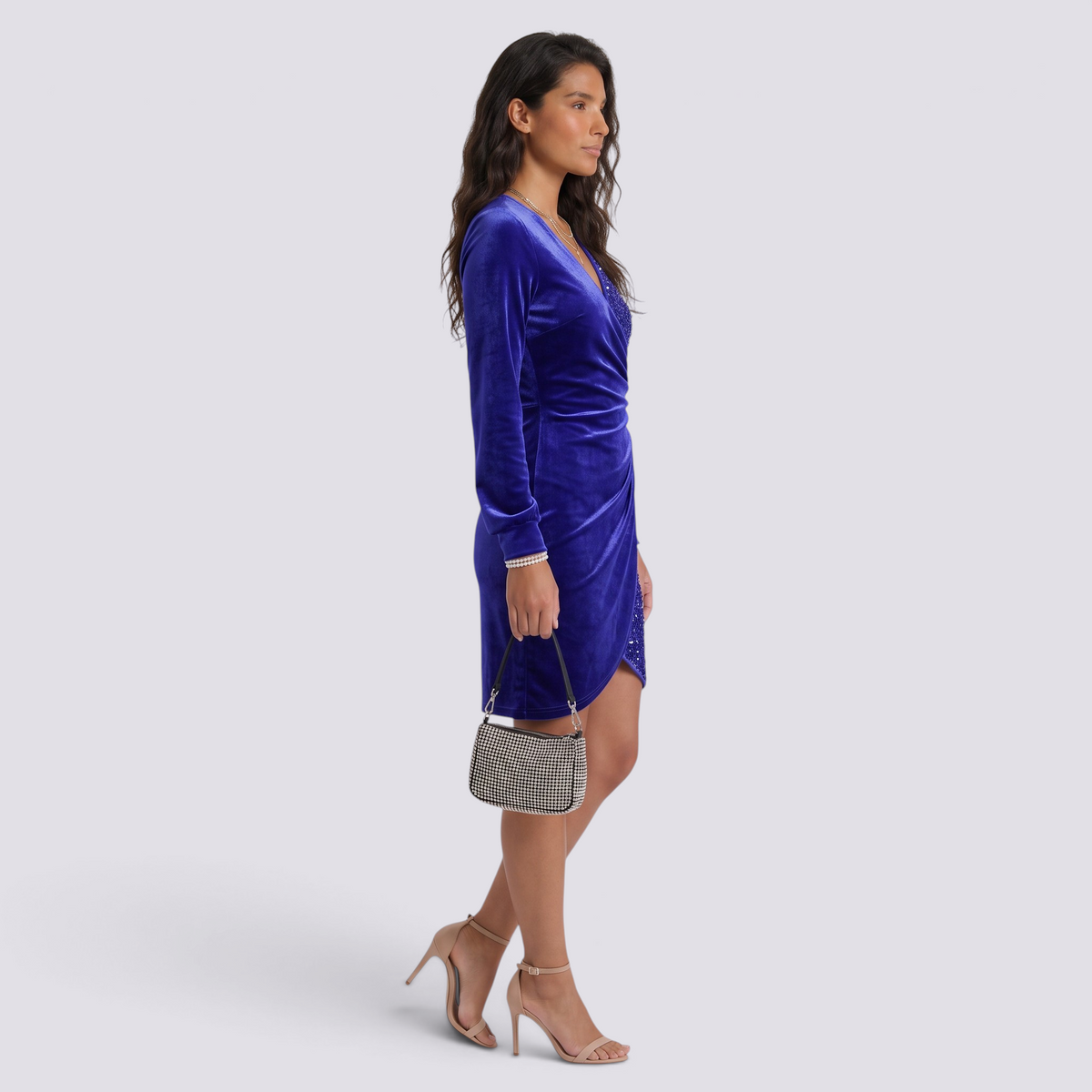 Essyro royal blue velvet party dress with V-neck, long sleeves, and sequin details worn by a model with heels.