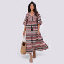 Essyro bohemian maxi dress with V-neck, short sleeves, and pink and black chevron pattern worn by a smiling woman.