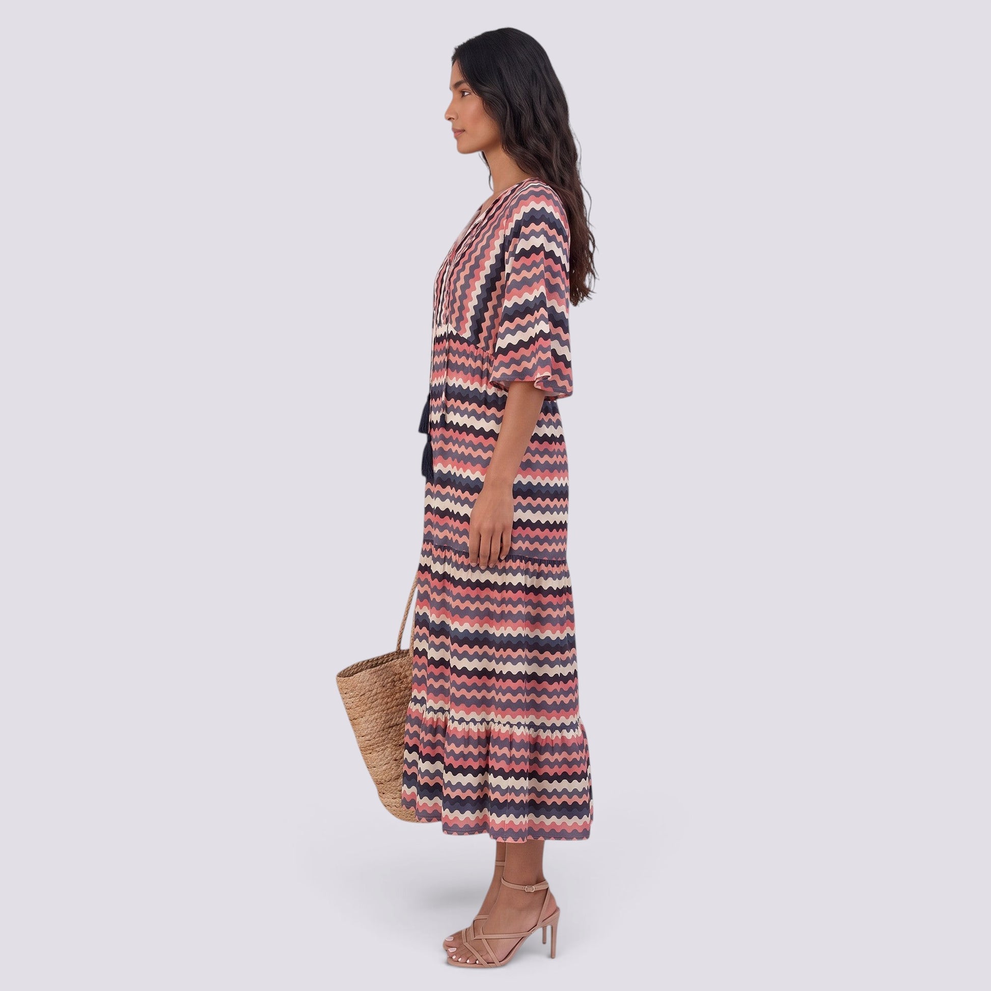 Essyro bohemian long maxi dress with V-neck, short sleeves, and a wavy pink and navy pattern on a model