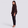 Essyro brown batwing sleeve cape with mandarin collar and thin black belt worn by a woman in profile view