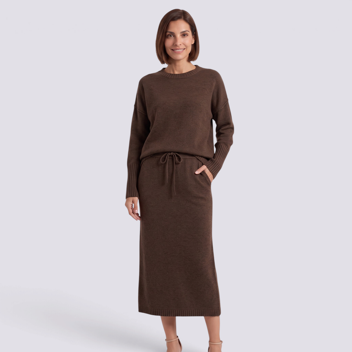 Essyro brown knit two-piece set featuring a loose crew neck sweater and a midi skirt with a drawstring waist.
