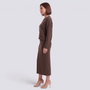 Essyro brown knit two-piece set with a loose sweater and midi skirt worn by a woman in profile view