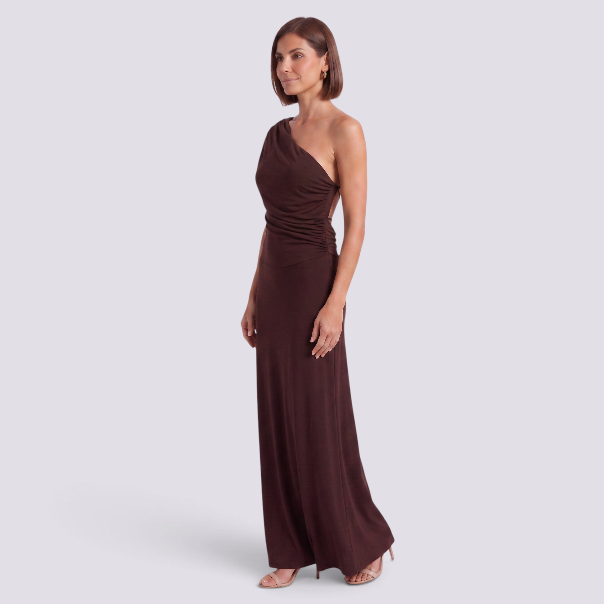 Essyro brown one-shoulder maxi dress with draped sleeve, ruched waist, and column skirt on a model