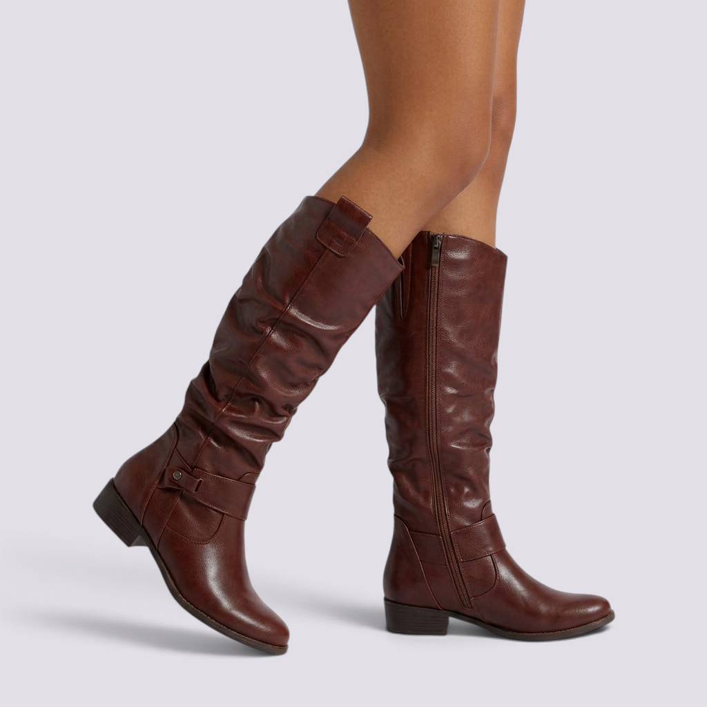 Essyro brown knee-high slouch boots with low block heel, side zipper, and decorative ankle strap with metal rivet