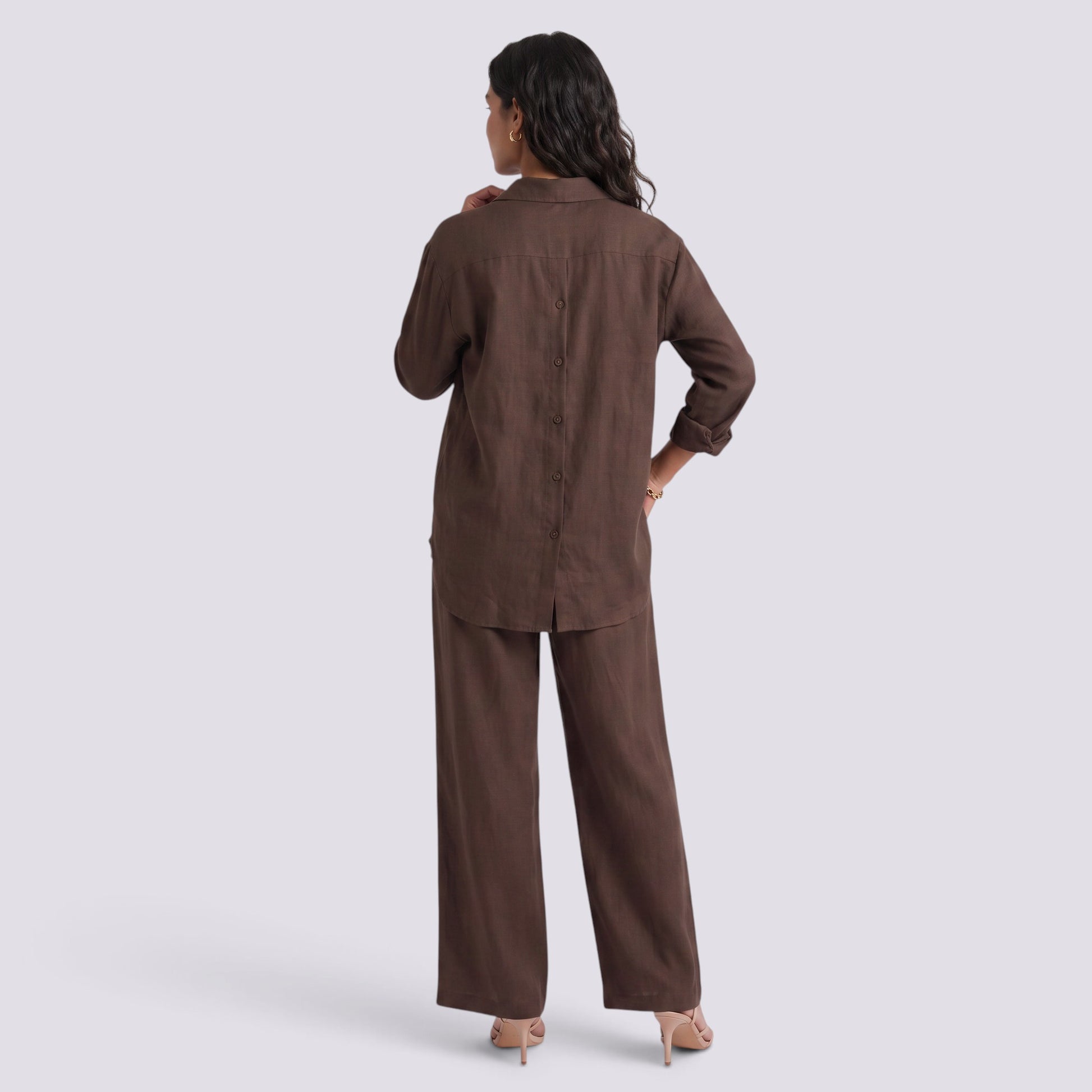 Essyro brown two-piece set featuring a long-sleeve button-back shirt and wide-leg trousers on a model, back view.