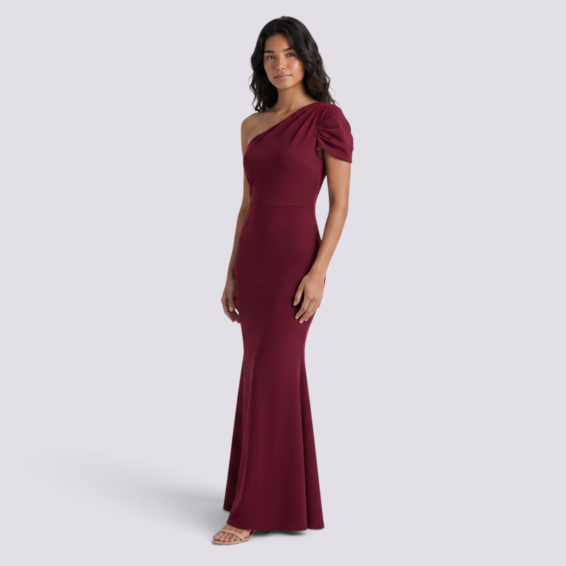 Essyro burgundy floor-length mermaid gown with an asymmetric one-shoulder neckline and draped sleeve detail