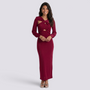 Essyro long-sleeve slim-fit midi dress in burgundy with a cutout knot detail at the waist worn by a smiling model