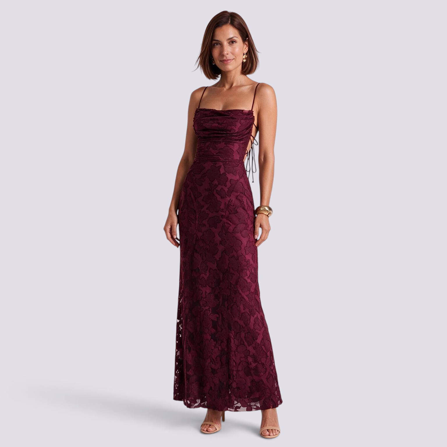 Essyro burgundy floral lace maxi dress with cowl neck, thin straps, and open back, worn by a woman on white background