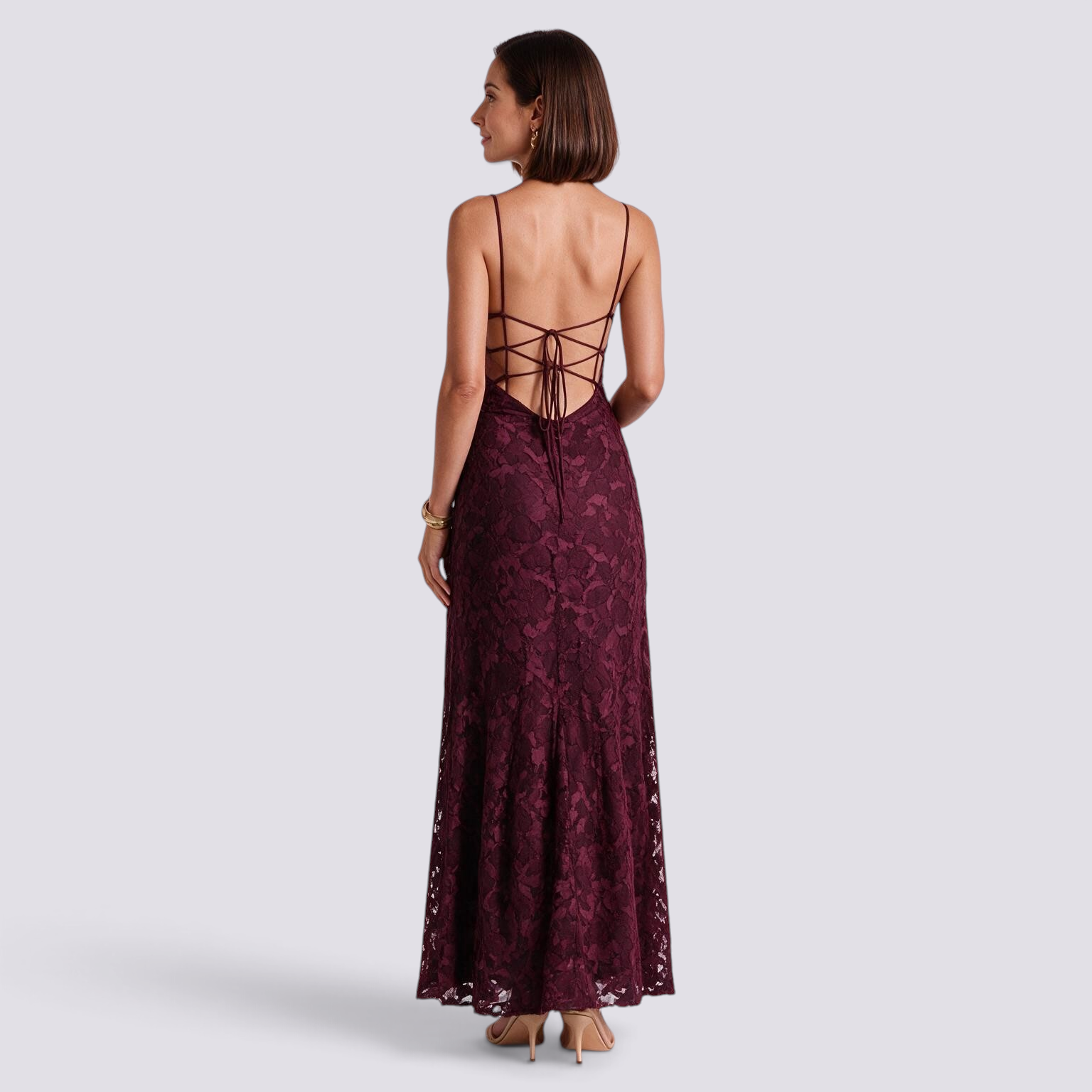 Essyro burgundy floral lace maxi dress with open back and crisscross tie straps on a model