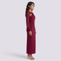 Essyro long-sleeve slim-fit midi dress in burgundy with a cutout knot detail at the waist worn by a model