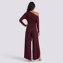 Essyro burgundy one-shoulder jumpsuit with long draped sleeve and wide-leg trousers, back view on a model.