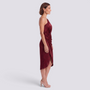 Essyro burgundy one-shoulder midi party dress with asymmetrical hem and draped waist detail on a model