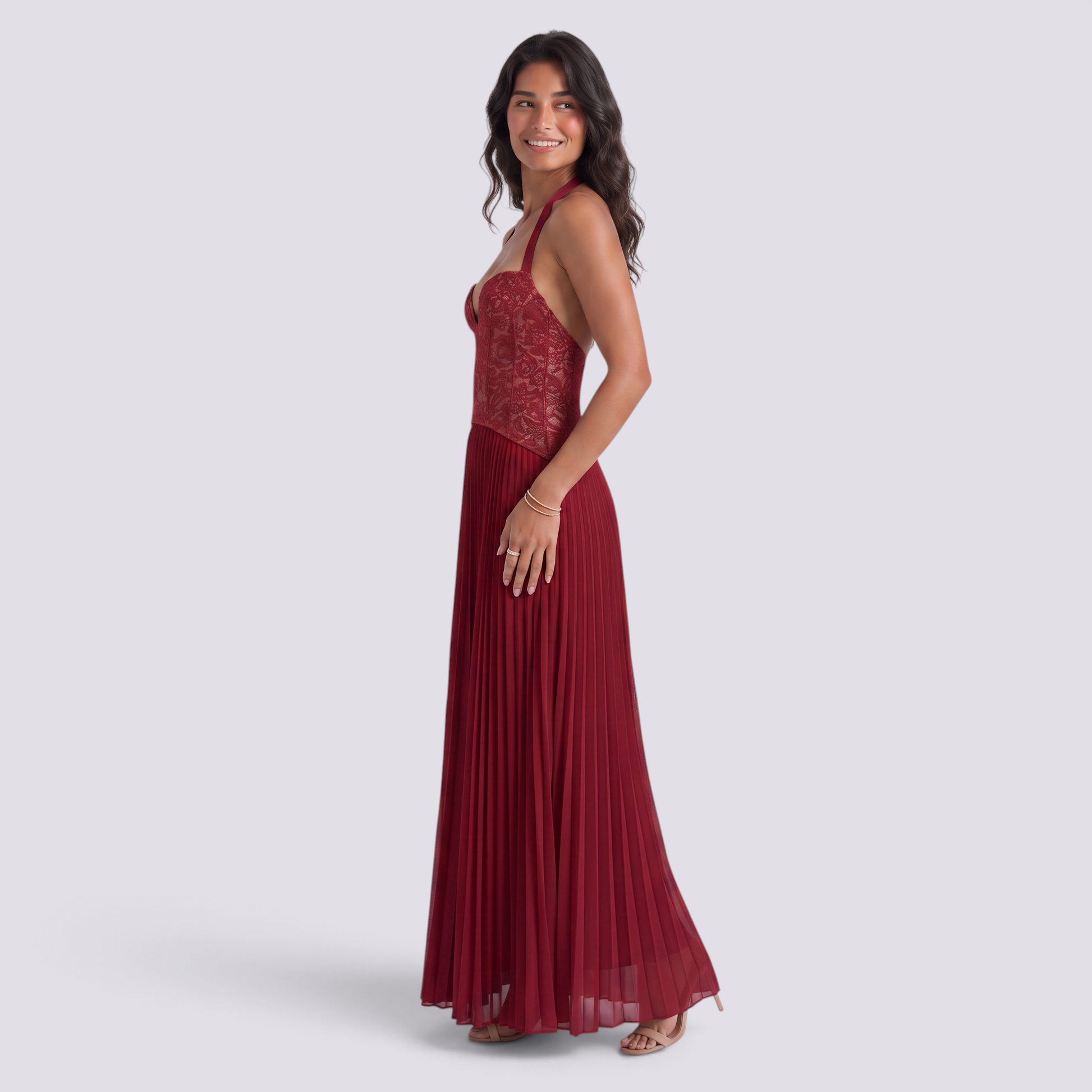 Essyro burgundy floor-length halter gown with a lace corset bodice and a flowing pleated skirt on a smiling model