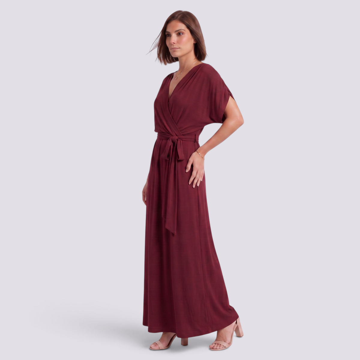 Essyro plus size elegant floor-length burgundy wrap dress with short sleeves and a tie waist on a model