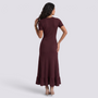 Essyro burgundy ribbed knit maxi dress with short sleeves and a ruffled hem, back view on a model