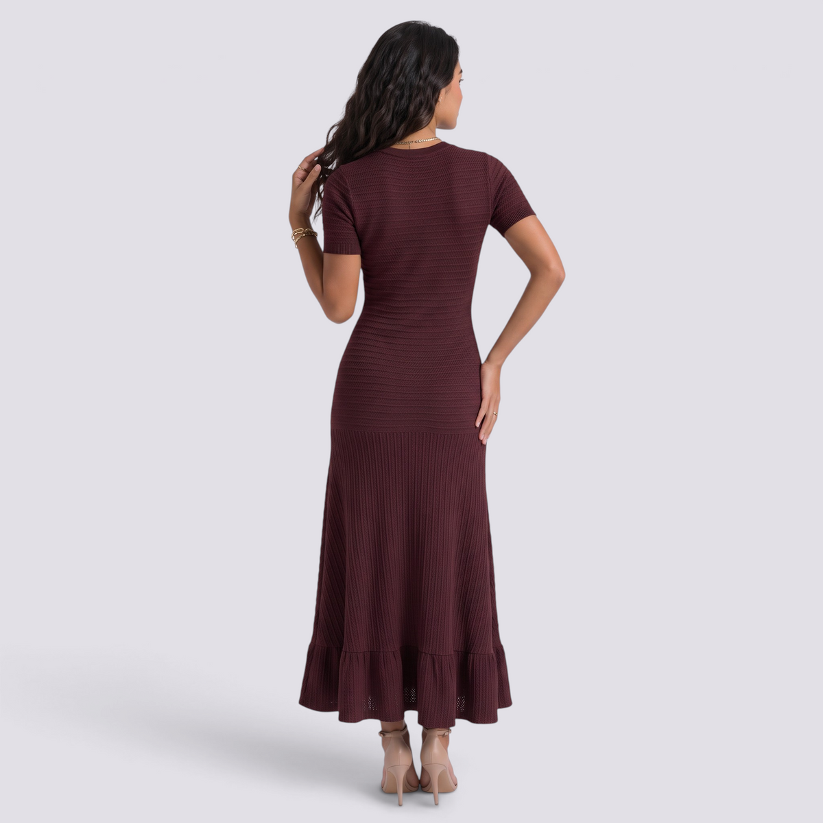 Essyro burgundy ribbed knit maxi dress with short sleeves and a ruffled hem, back view on a model