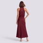 Essyro burgundy satin halter neck maxi dress with open back and draped detail worn by a model from the back view