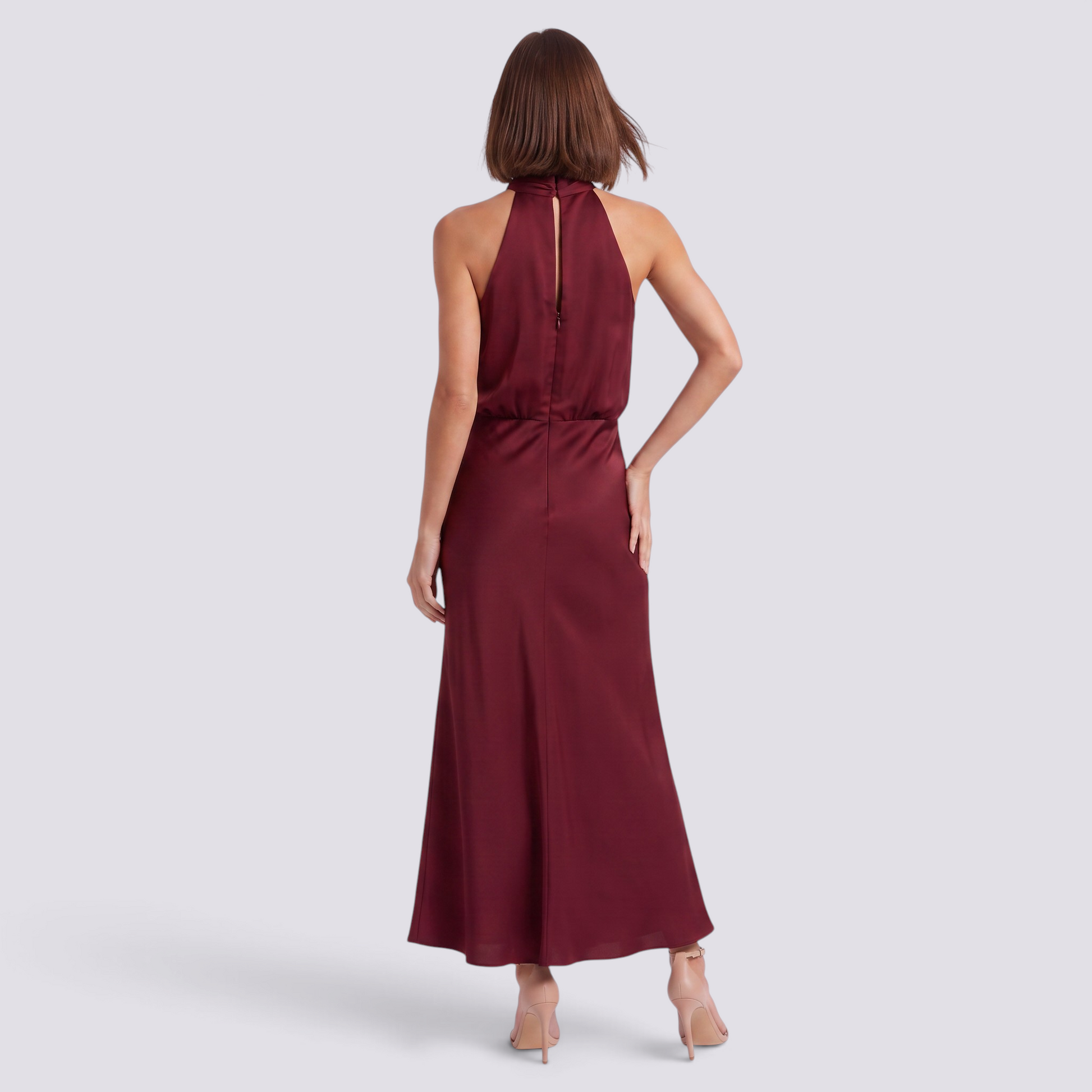 Essyro burgundy satin halter neck maxi dress with open back and draped detail worn by a model from the back view