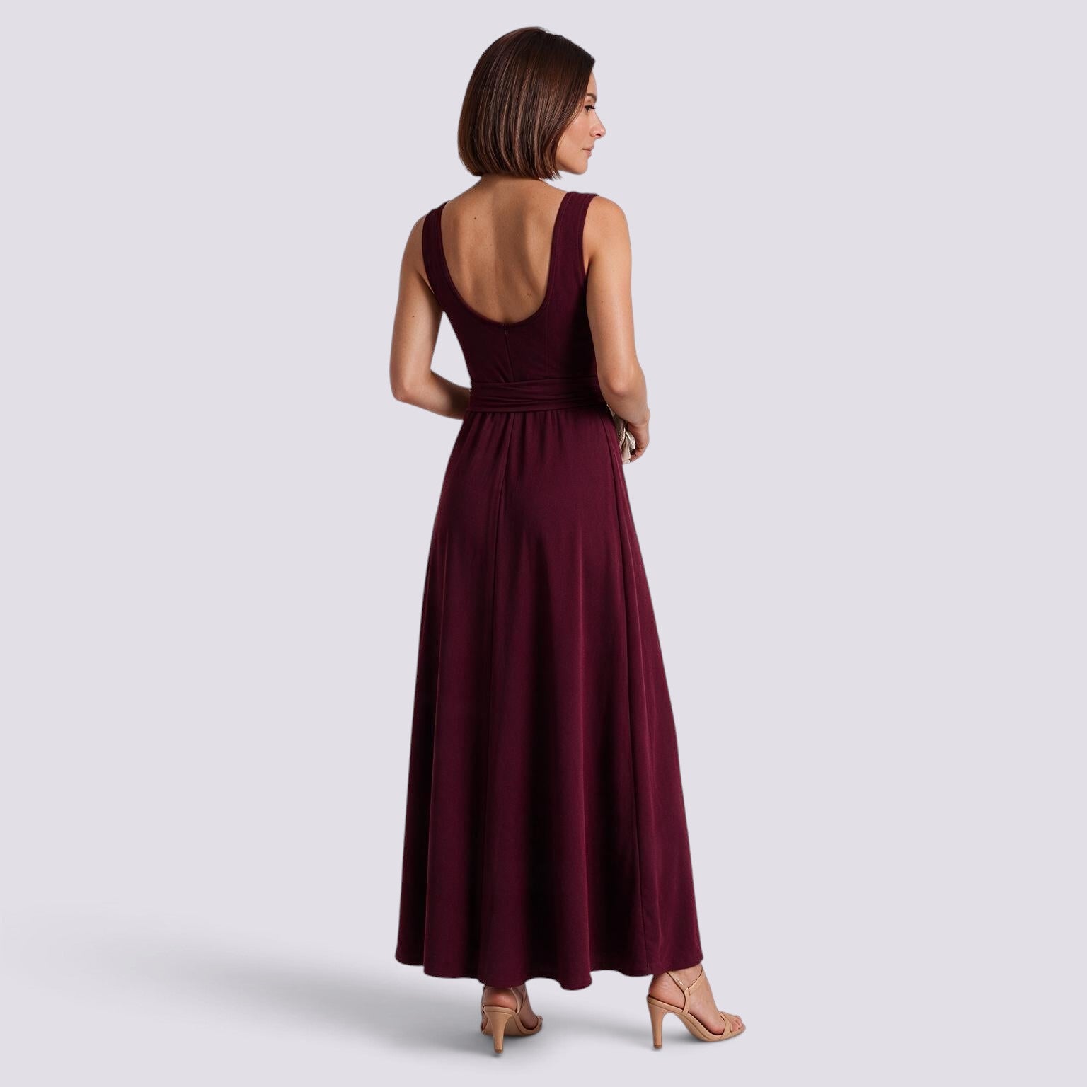 Essyro burgundy sleeveless maxi dress with a V-neck and waist belt worn by a woman, back view