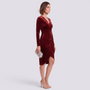 Essyro burgundy velvet cocktail dress with V-neck, long sleeves, and an irregular hemline on a model