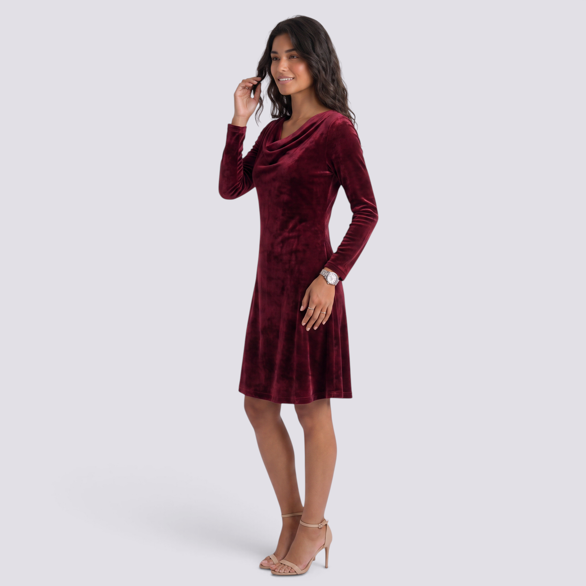 Essyro burgundy velvet short dress with a draped cowl neck and long sleeves worn by a smiling model.