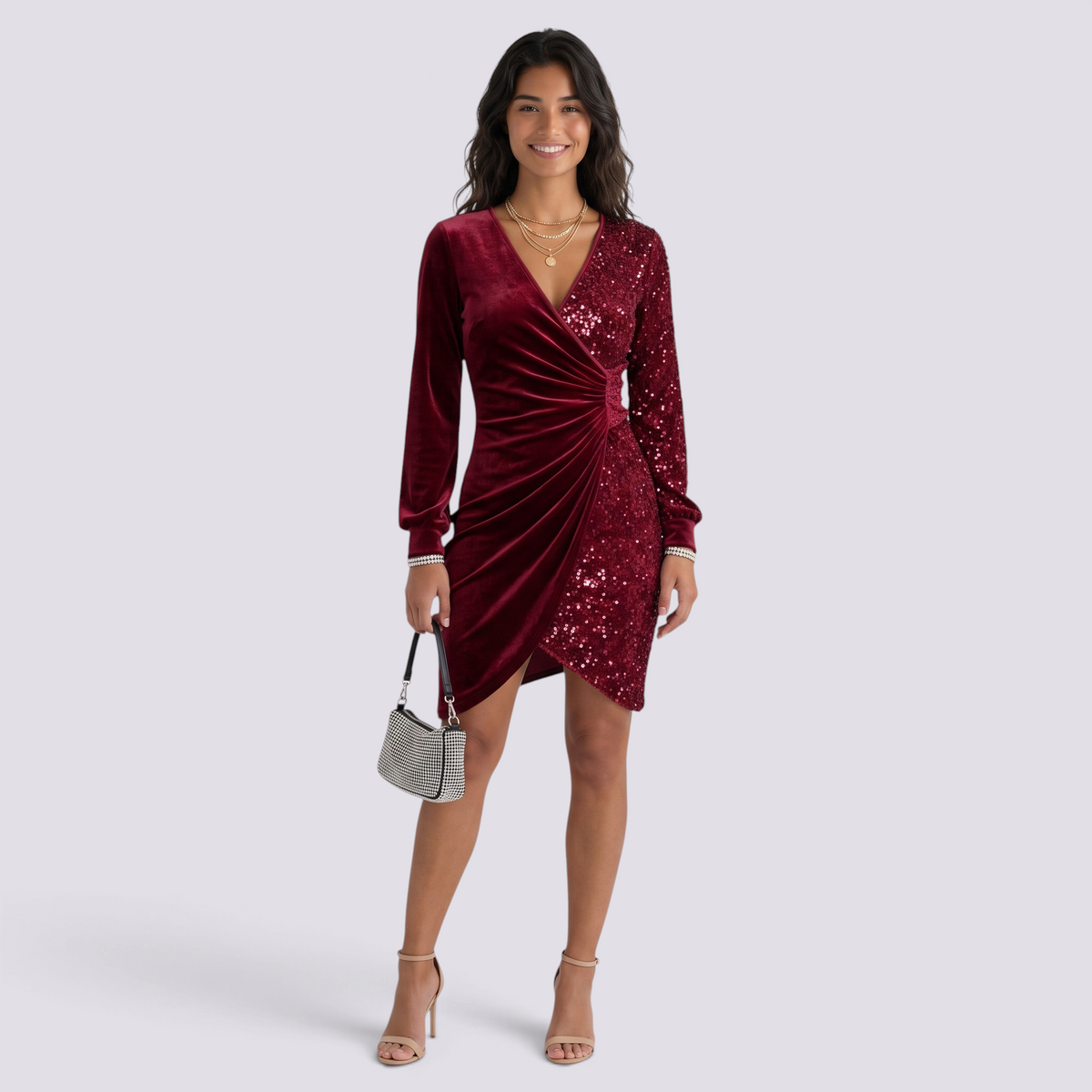 Essyro burgundy velvet and sequin party dress with V-neck, long sleeves, and draped waist on a smiling model