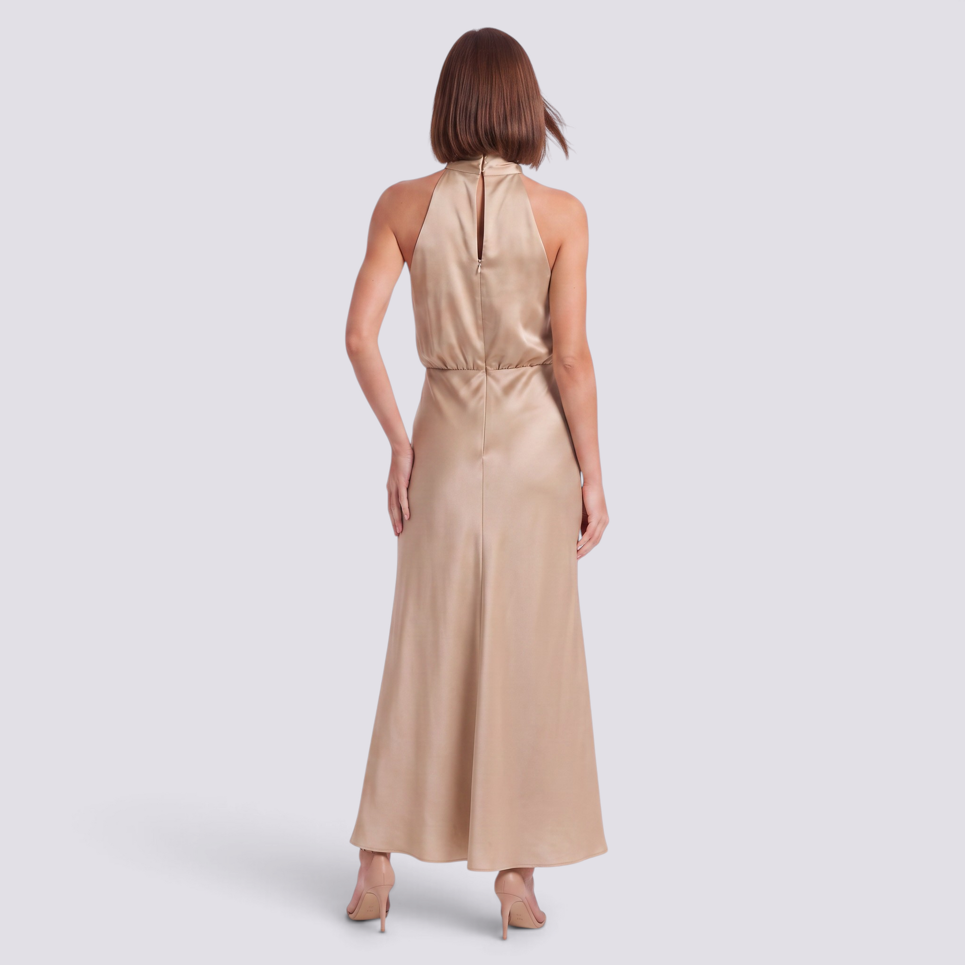 Essyro champagne satin maxi dress with halter neck, open back, and flowing bias-cut skirt on a model