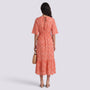 Essyro coral boho maxi dress with V-neck, short sleeves, and geometric print, worn by a model from the back view.