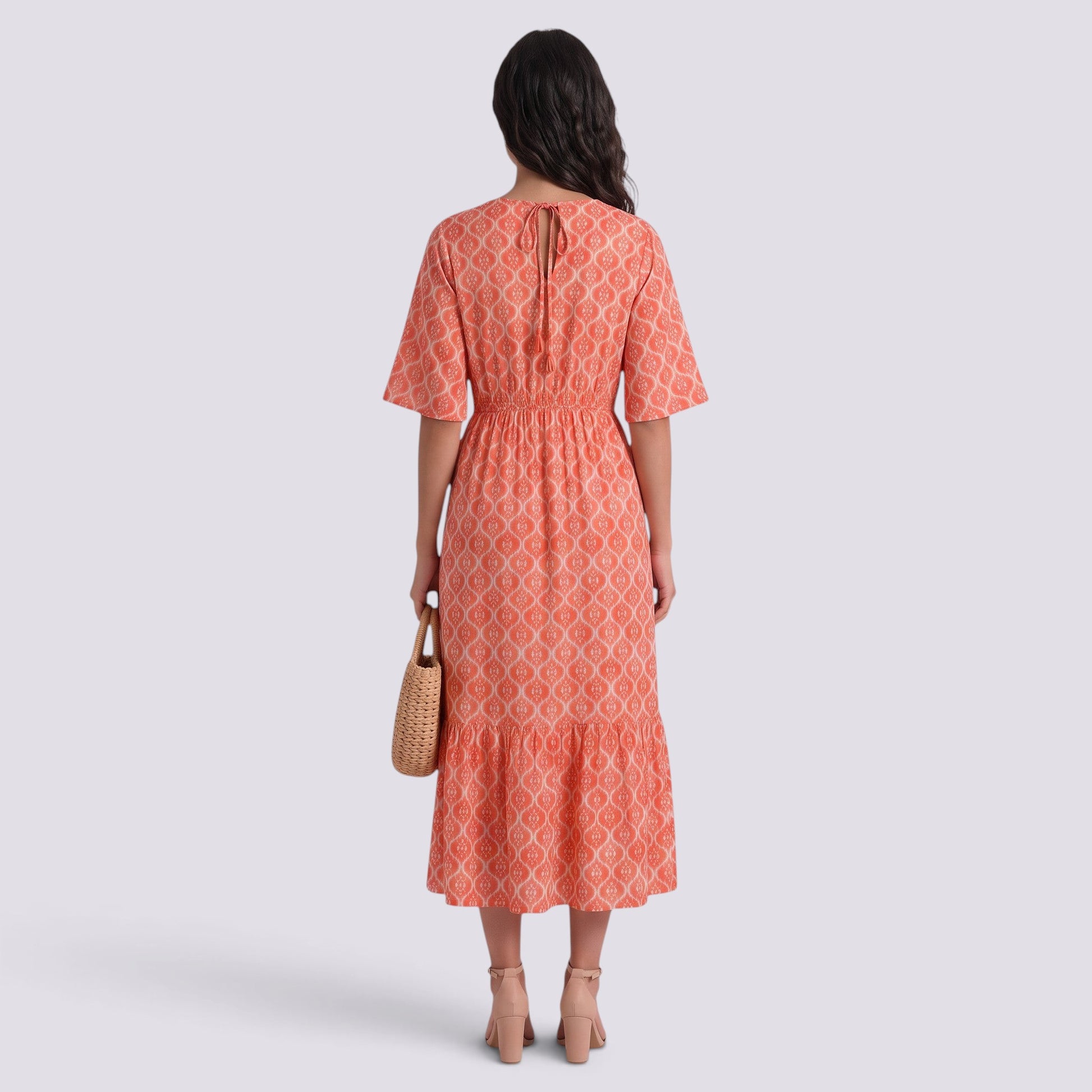 Essyro coral boho maxi dress with V-neck, short sleeves, and geometric print, worn by a model from the back view.
