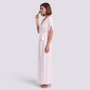 Essyro elegant floor-length cream wrap dress with delicate straps and a tie waist worn by a woman in profile view
