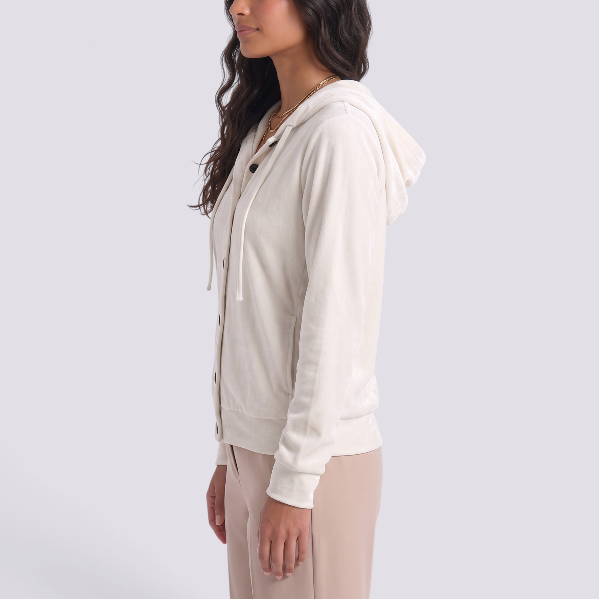Essyro cream velvet hooded cardigan with button front, drawstring hood, and side pockets, side view on a model.