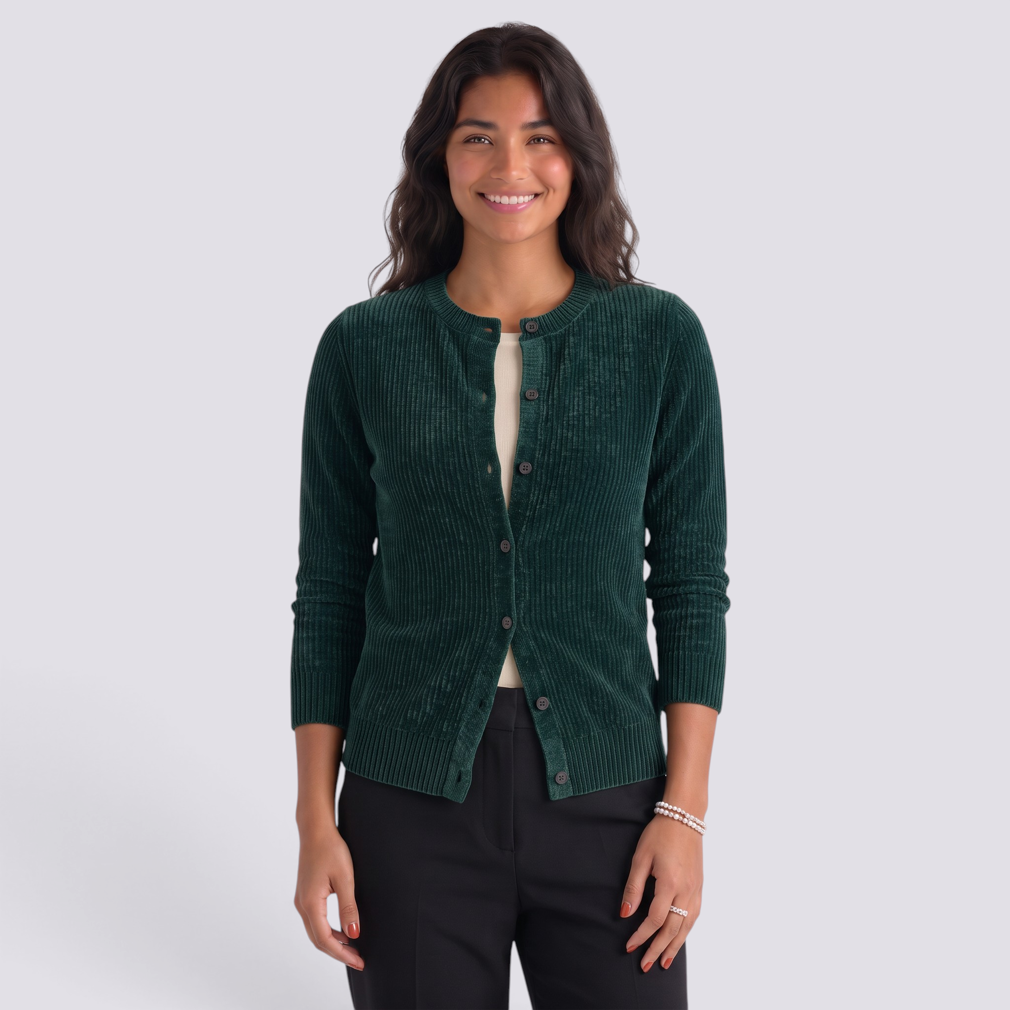 Essyro dark green ribbed wool cardigan with a round neck and button front worn by a smiling woman