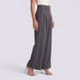 Essyro high-waisted dark grey tailored wide-leg trousers with front pleats worn by a model with beige heels.