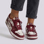Essyro women's vintage-style skate sneakers in burgundy and white with distressed finish and heart-shaped lace charm.