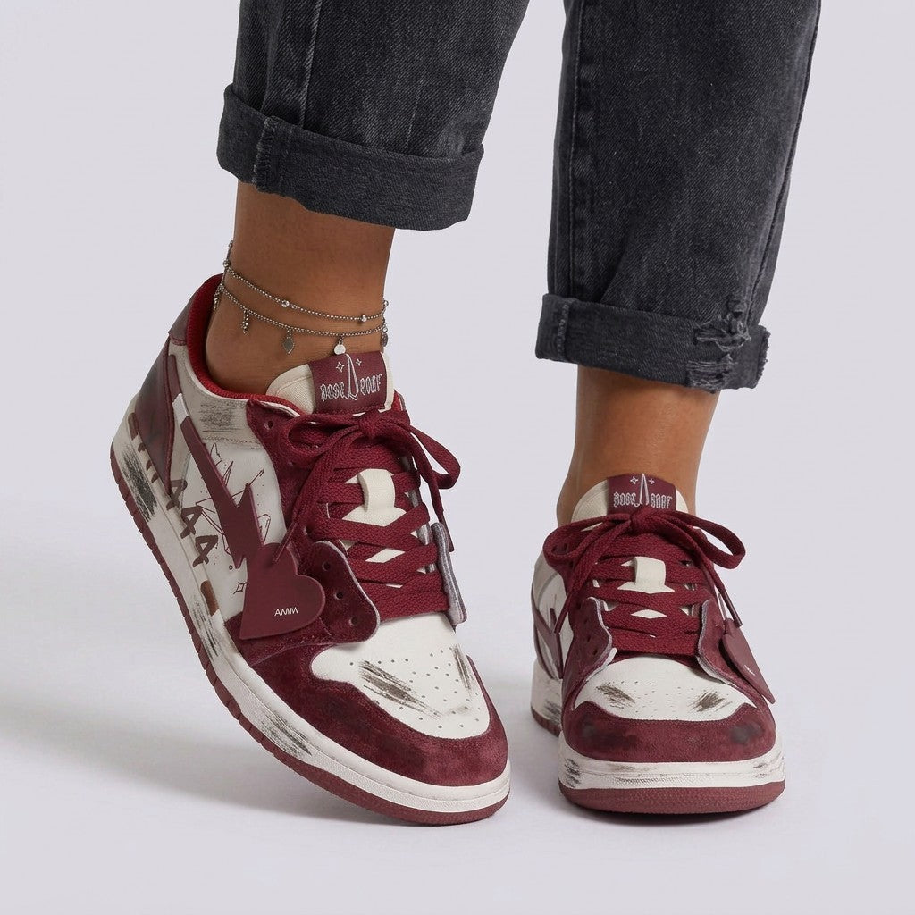 Essyro women's vintage-style skate sneakers in burgundy and white with distressed finish and heart-shaped lace charm.