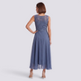 Essyro midi dress in dusty blue with intricate lace back detail and flowing skirt, worn by a woman from behind.