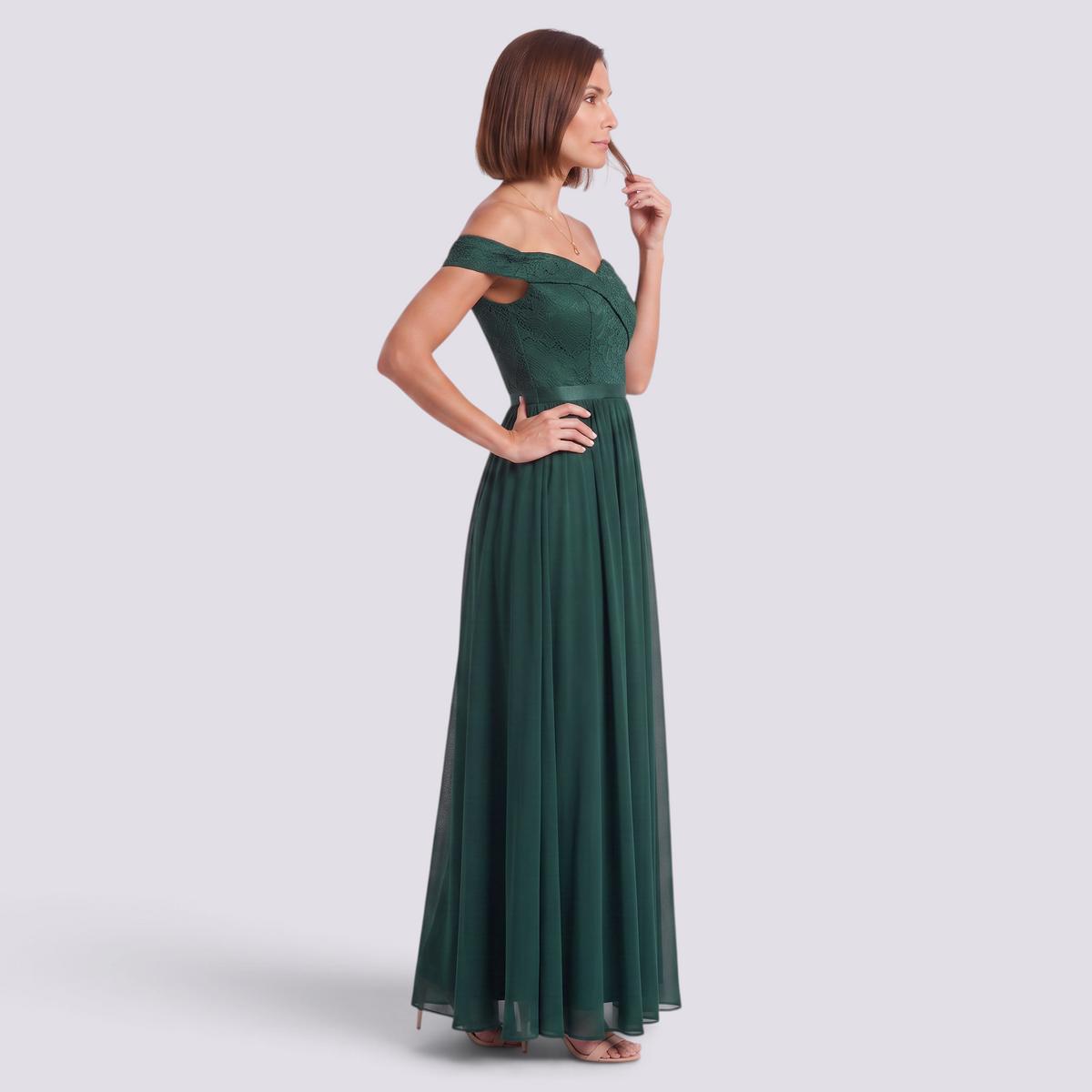 Essyro emerald green floor-length formal gown with a lace bardot bodice and a flowing A-line skirt on a model