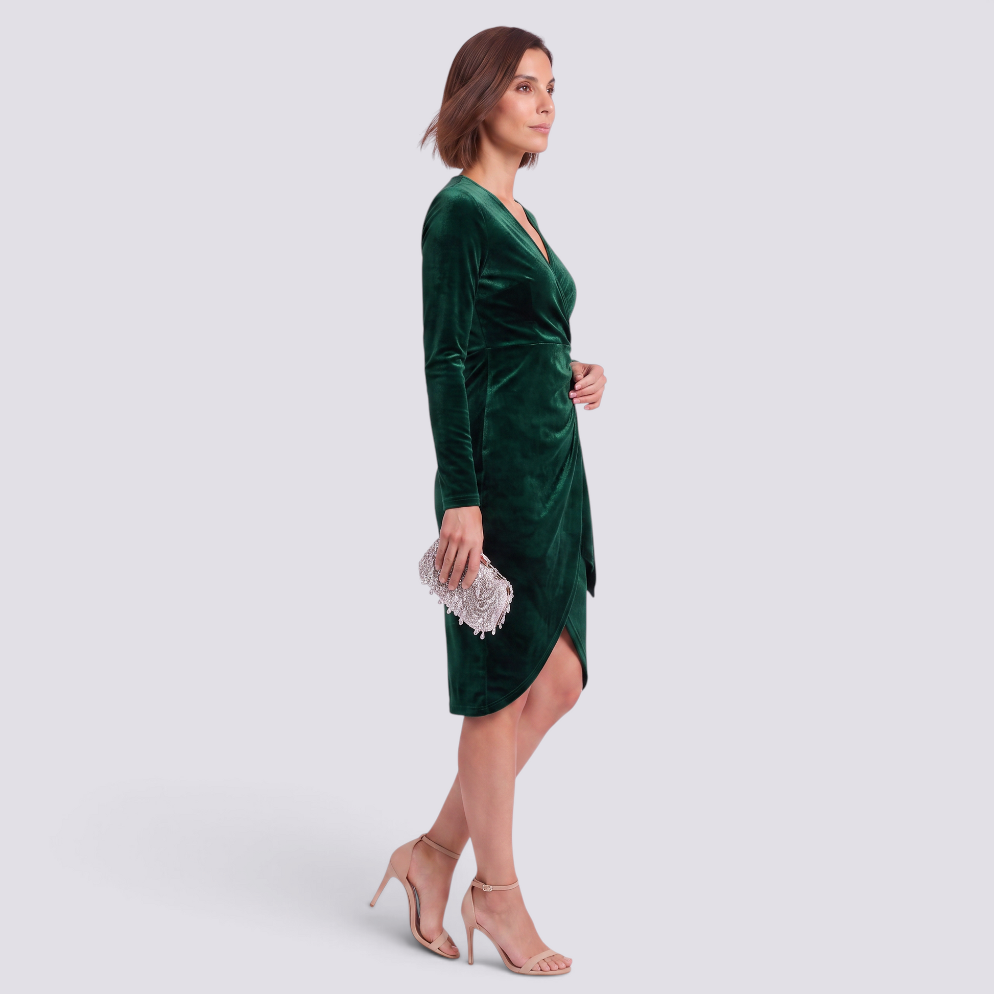 Essyro emerald green velvet cocktail dress with V-neck, long sleeves, and irregular hemline on a model