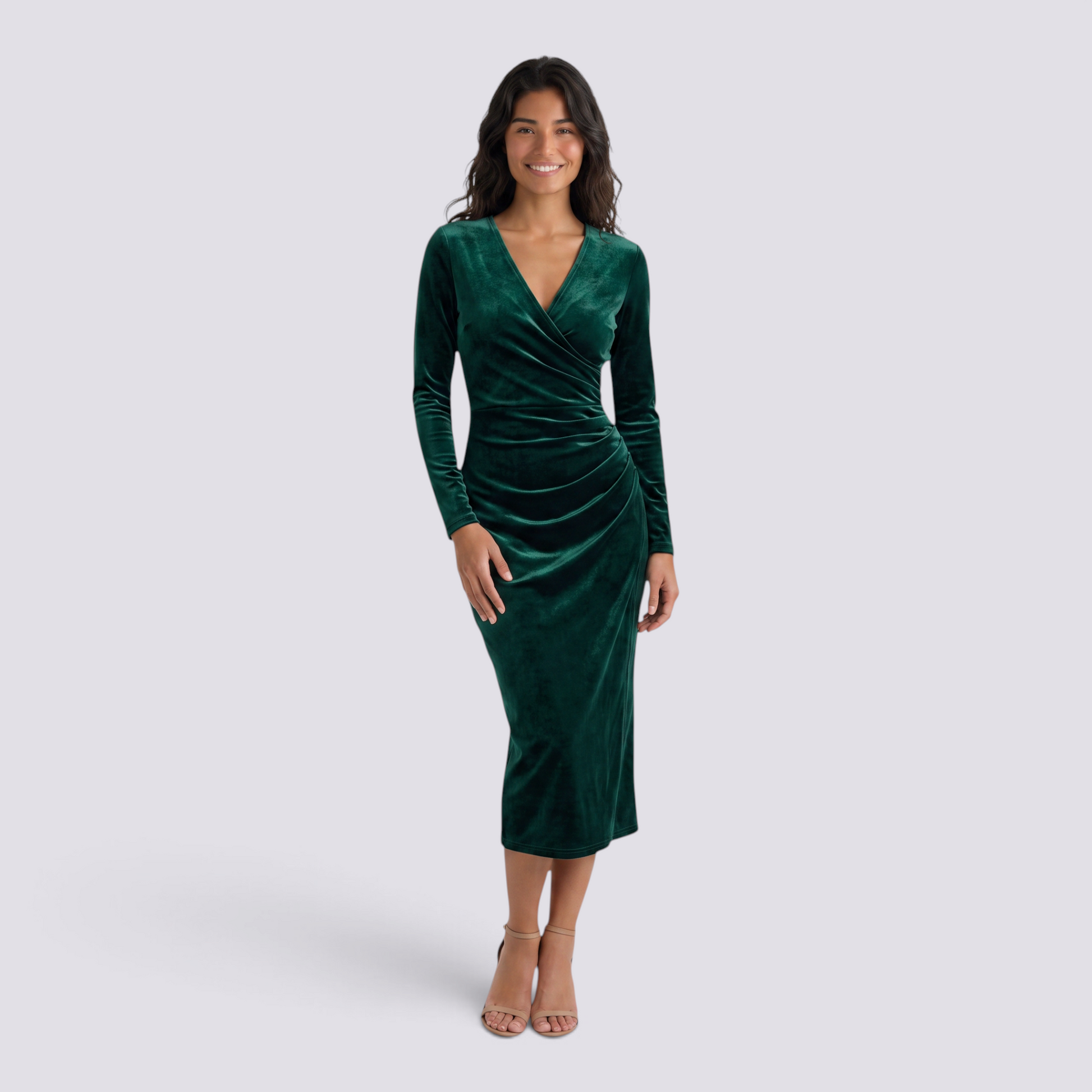 Essyro emerald green velvet midi dress with long sleeves, V-neck wrap design, and draped waist on a smiling model.