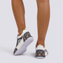Essyro chunky dad sneakers with a woven ethnic pattern and white sole worn on feet against a plain background