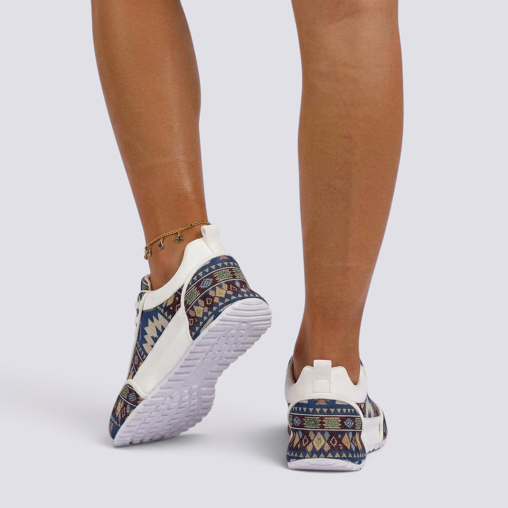 Essyro chunky dad sneakers with a woven ethnic pattern and white sole worn on feet against a plain background