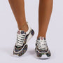 Essyro chunky dad sneakers featuring a woven ethnic pattern, white laces, and a cushioned sole on a model
