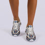 Essyro unisex dad shoe sneakers featuring a woven ethnic pattern, chunky white sole, and front lace-up closure.
