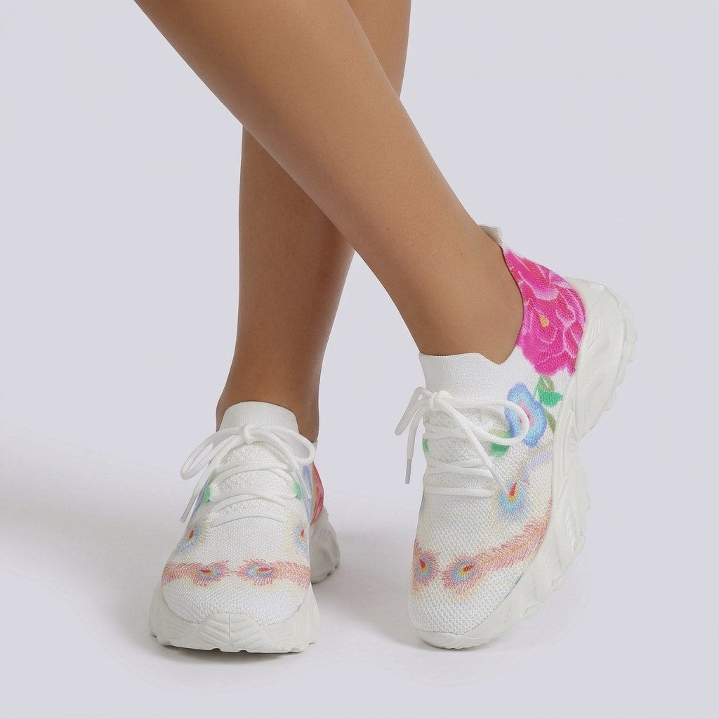 Essyro women's flying-woven sneakers in white with vibrant floral print, breathable fabric, and white rubber sole.
