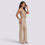 Essyro gold sequin halter neck jumpsuit with wide legs and draped neckline worn by a model on a white background